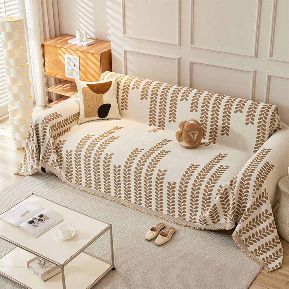 Sofaovertrekk med bladmønster og frynser – eleganse og komfort 